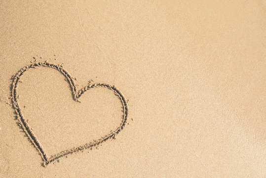 Heart written on the sand