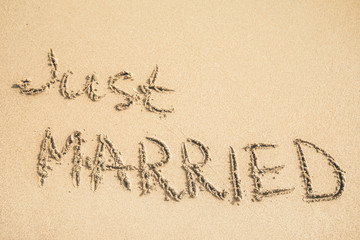 Just Married text written on the sand