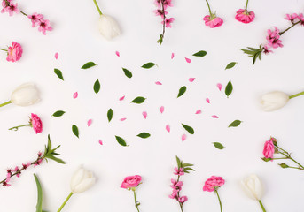 Fototapeta na wymiar backdrop, calmness, women day concept. adorable background of snowy white colour with flowers on it, they are placed on the edges and creat a frame, surrounding leaves and petals