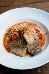 Grilled sea bass and spaghetti with tomato sauce