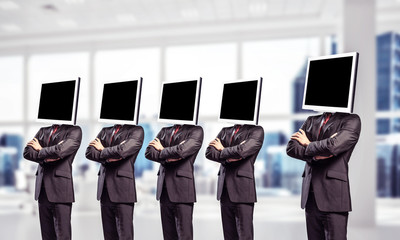 Businessmen with monitors instead of head.