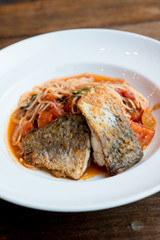 Grilled sea bass and spaghetti with tomato sauce