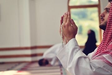 Religious muslim man praying inside the mosque