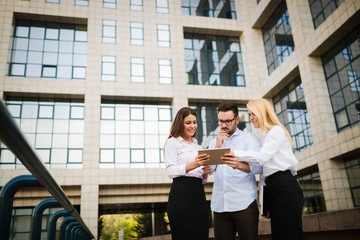 Picture of young attractive business partners standing