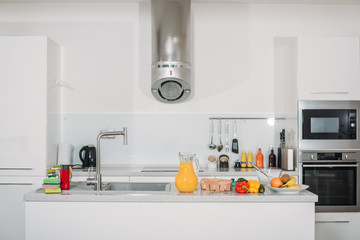 fruits, vegetables and orange juice on kitchen table