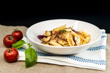 Pasta with pesto sauce and nuts on a the table