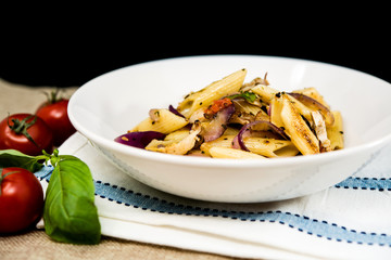 Pasta with pesto sauce and nuts on a the table