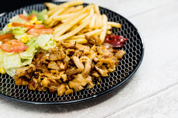 Fresh chicken with tomatoes and french fries