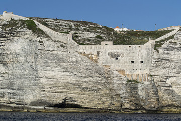 historic defensive wall on a cliff overlooking the sea in the port of Bonifacio on the island of Corsica