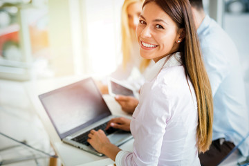 Young employee working on computer during working day in office