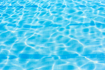 Naklejka na ściany i meble Water abstract background, Swimming pool rippled.Under water tile of swimming pool floor.