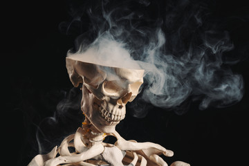 Skeleton with smoke coming out of open skull