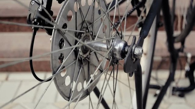 Closeup footage of old bicycle wheel slowly rotating