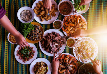 Family having enjoying dinner with seafood