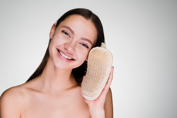 young smiling girl holding a pumice stone