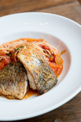 Grilled sea bass and spaghetti with tomato sauce