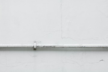 white water pipeline on cement wall.