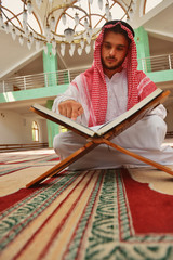 Fototapeta premium Religious muslim man praying inside the mosque