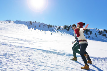 Couple having fun running down slope