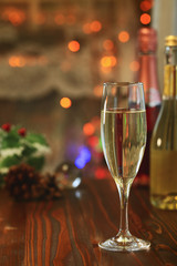A glass of Sparkling wine in front of defocused colorful lights, evening warm tone background_2