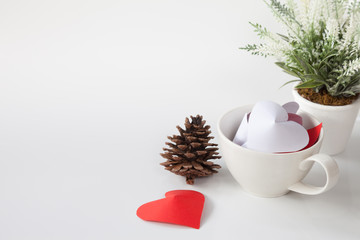 Paper heart in cup of coffee and decorative items. This is the symbol of love. For In February 14th, which was a day of love.