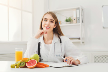 Obraz na płótnie Canvas Nutritionist desk with fruit and measuring tape