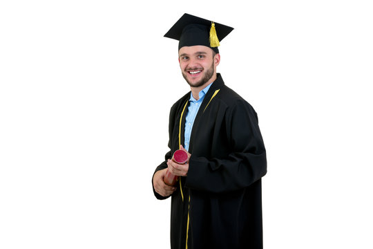 Cheerful Smiling Male Graduate Wearing Gown And Cap Isolated On White