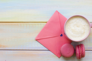 Macaroons, coffee and pink envelope