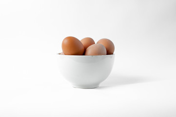 Brown eggs in a bowl, isolated
