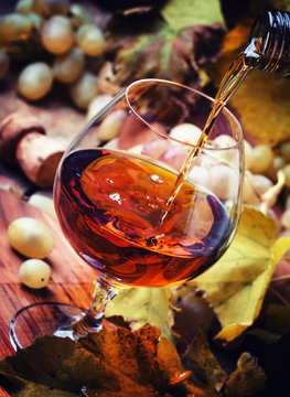 Cognac Pour In Glass, Grapes And Vine, Vintage Wood Background, Selective Focus