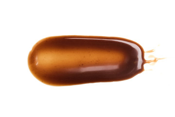 Chocolate caramel sauce stripe on a plain white backround