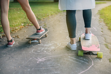 Girls on a skateboard. Park background.