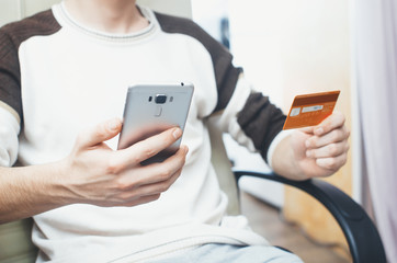 men hands, holding the phone and a visa card or other