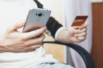men hands, holding the phone and a visa card or other