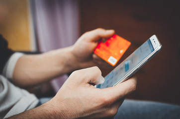 men hands, holding the phone and a visa card or other