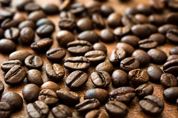 Roasted coffee beans on brown rustic background