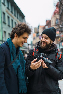 Cheerful men watching camera