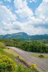 Highway road between mountain and blue sky.