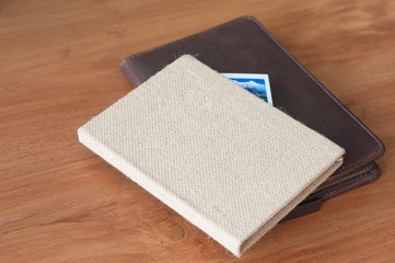 Double notebook traveling book lay on wooden table.