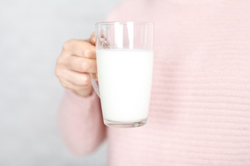 woman offers to drink a mug of milk