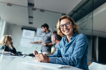 Woman sitting in board room during business meeting