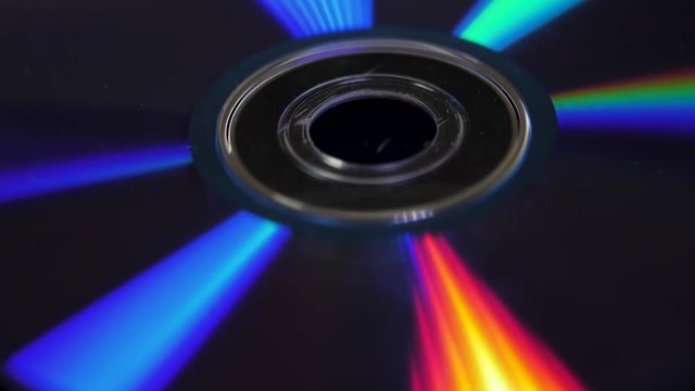 Background of compact disks or dvds. Glare of light on the disk DVD , beautiful colored glare from the light, the background disk DVD