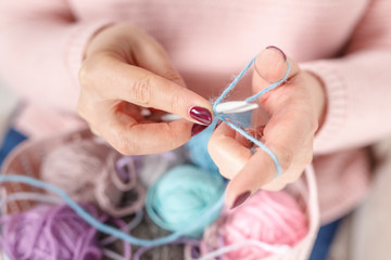 Female knitting colored yarn