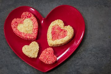 Homemade Rice Krispie Crispy  hearts in red plate / Valentines day food background
