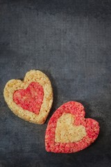Obraz na płótnie Canvas Homemade Rice Crispy hearts with copy space / valentines day food top view
