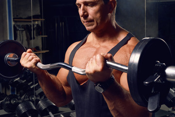 Athletic, adult man exercising in the gym