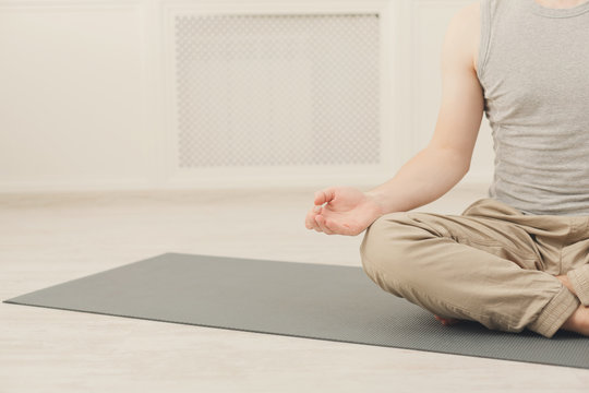 Young man in yoga class, relax meditation pose