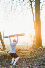 Young man doing workout with tree at sunrise in Austria