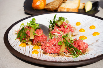 tasty Steak tartare (Raw beef) - classic steak tartare on white plate