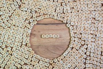 Abgas, German text for exhaust, word in letters on cube dices on table